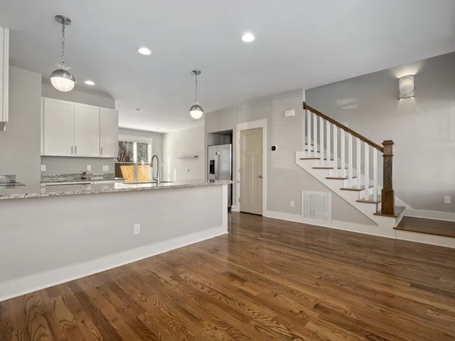 a view of kitchen with wooden floor and window