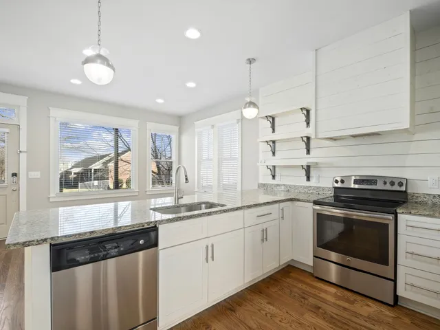 a kitchen with a sink stove and microwave