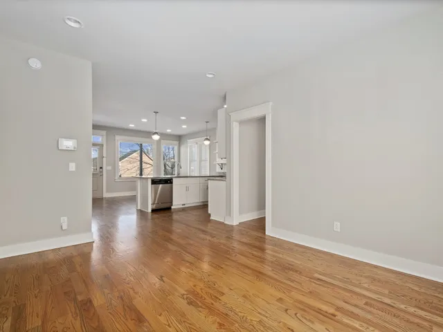 a view of kitchen with refrigerator and window