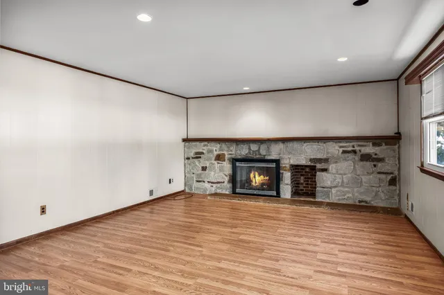 a view of a kitchen with stainless steel appliances wooden floor and a large window