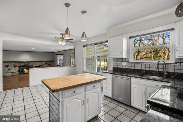 a kitchen with stainless steel appliances granite countertop a sink and a stove