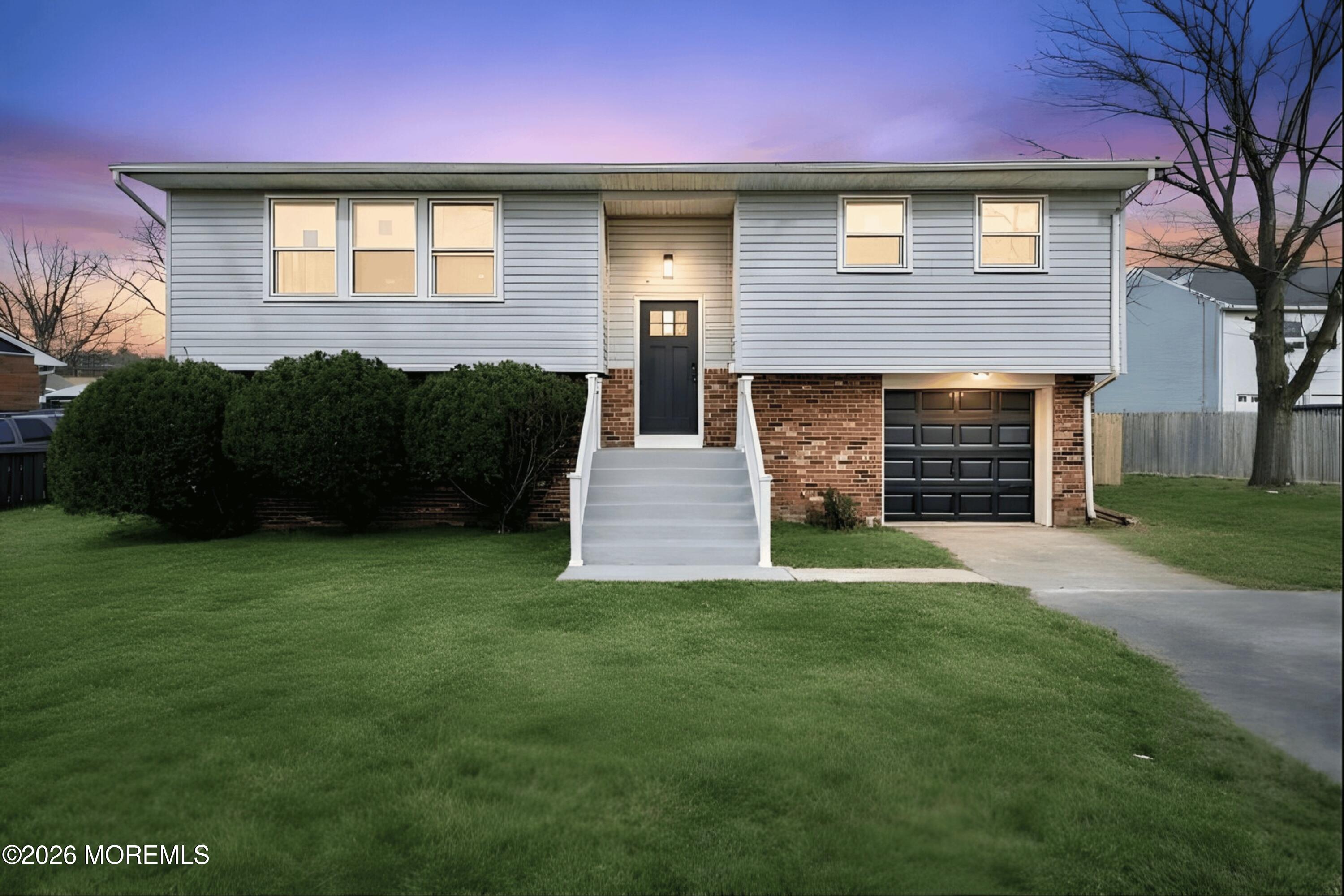 a front view of a house with a garden