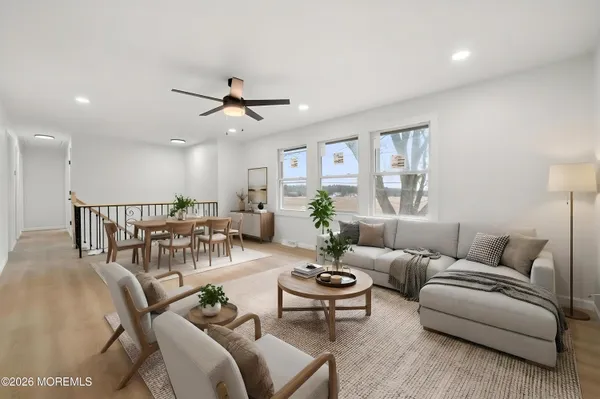 a view of a livingroom with a ceiling fan and window