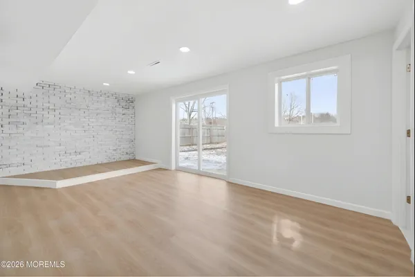 a kitchen with granite countertop a sink cabinets and stainless steel appliances