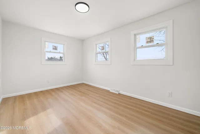 an empty room with a painting on the wall