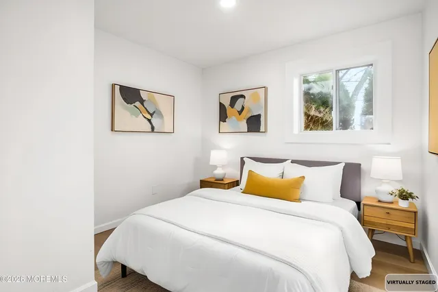 a bedroom with a bed and a wall painting