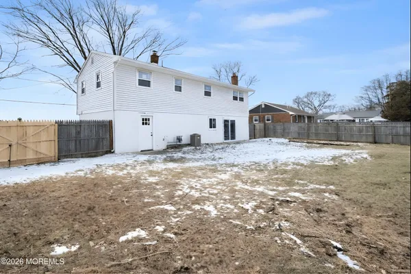 a view of a white house with a yard