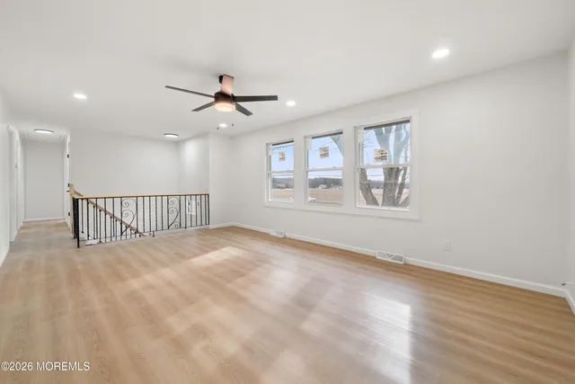 a view of a livingroom with a ceiling fan and window