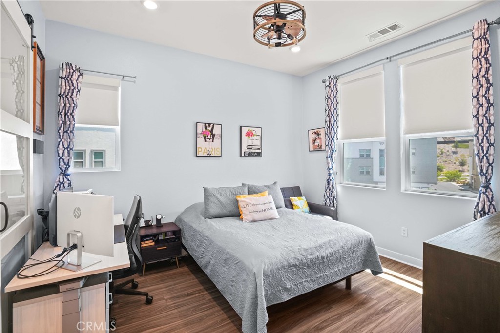 26973 West Prospector Road, Unit 302 Valencia, CA 91381 - Photo 11 of 22 a bedroom with a bed and wooden floor