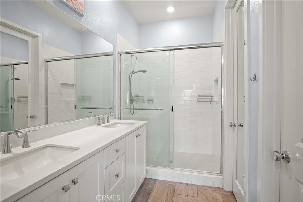 26973 West Prospector Road, Unit 302 Valencia, CA 91381 - Photo 13 of 22 a bathroom with a double vanity sink and mirror with shower