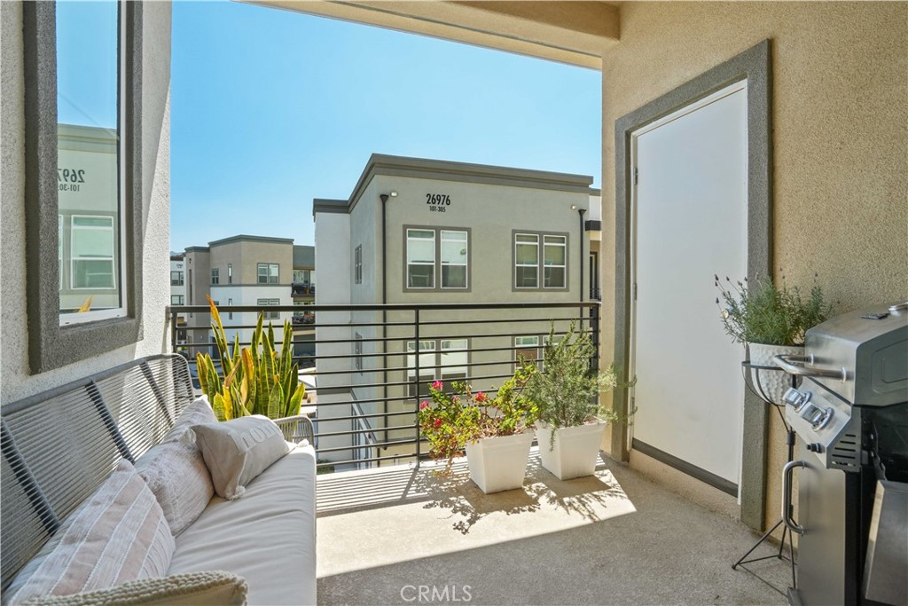 26973 West Prospector Road, Unit 302 Valencia, CA 91381 - Photo 15 of 22 a living room with furniture and a fireplace