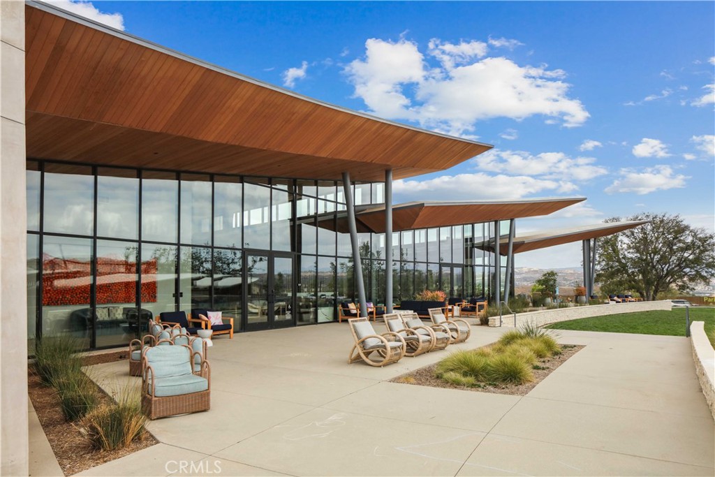 26973 West Prospector Road, Unit 302 Valencia, CA 91381 - Photo 20 of 22 a view of a patio with a table and chairs under an umbrella