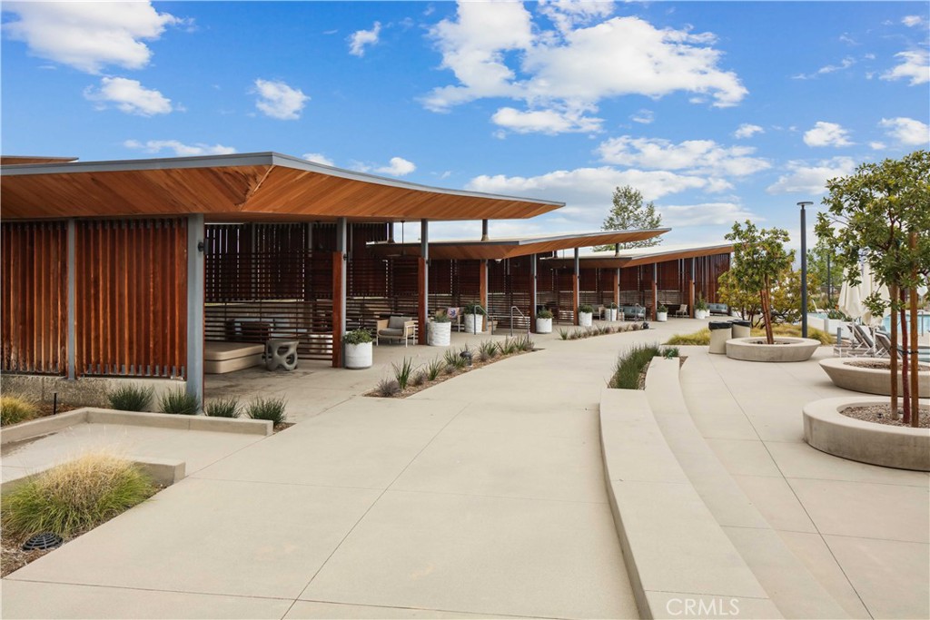 26973 West Prospector Road, Unit 302 Valencia, CA 91381 - Photo 21 of 22 a swimming pool with outdoor seating and yard