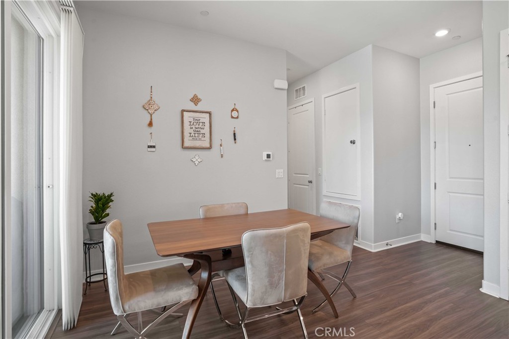 26973 West Prospector Road, Unit 302 Valencia, CA 91381 - Photo 8 of 22 a view of a dining room with furniture and wooden floor