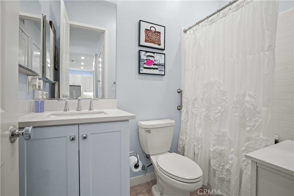 26973 West Prospector Road, Unit 302 Valencia, CA 91381 - Photo 10 of 22 a bathroom with a toilet sink and a mirror