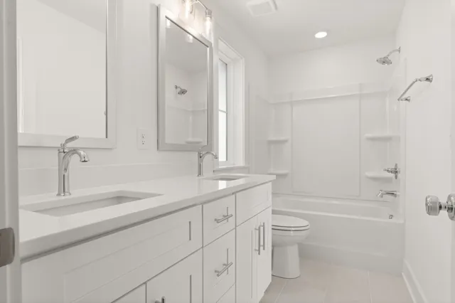 a bathroom with a granite countertop sink a toilet and shower