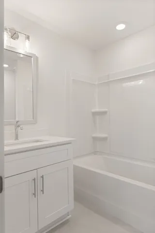 a bathroom with a bathtub and a sink