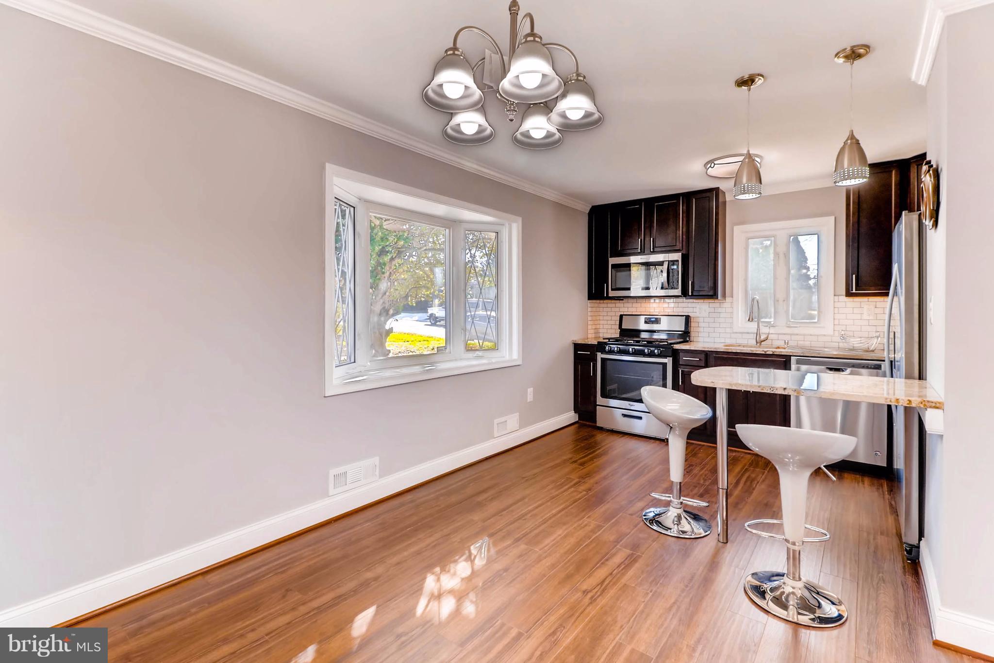 7508 Marston Road Baltimore, MD 21207 - Photo 8 of 18 a view of a dining room with furniture and wooden floor