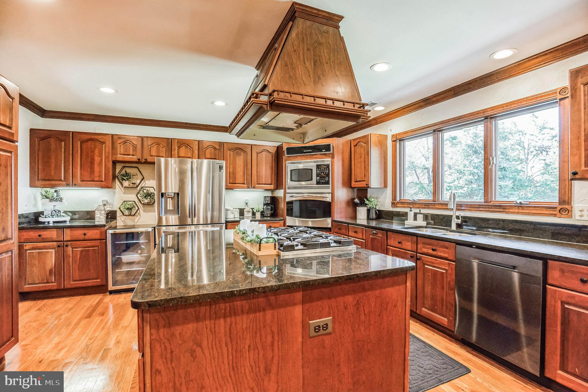 3310 Holland Cliffs Road Huntingtown, MD 20639 - Photo 14 of 40 a kitchen with stainless steel appliances granite countertop a sink stove and refrigerator