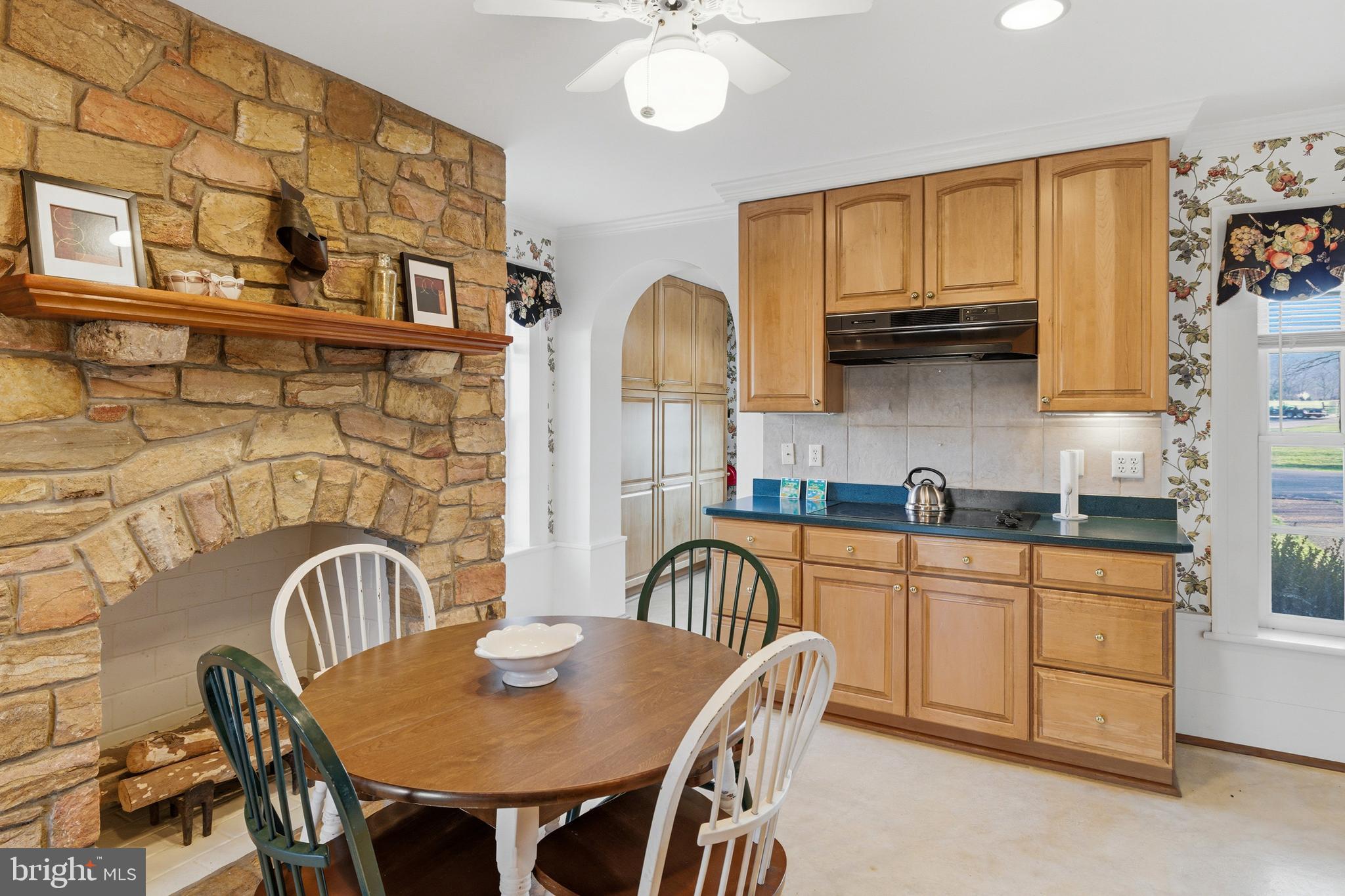5329 Farmview Road Stanley, VA 22851 - Photo 15 of 111 a kitchen with granite countertop a dining table chairs and a refrigerator