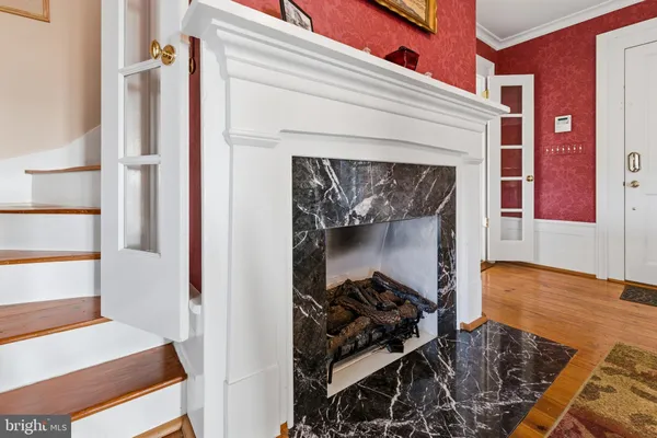 a view of entryway and hall with wooden floor
