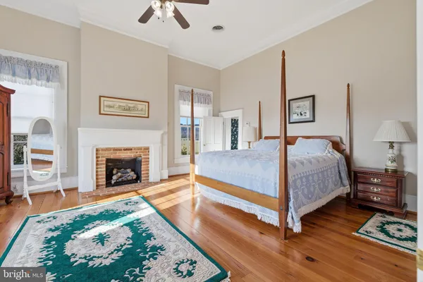 a view of a dining room with furniture large windows and wooden floor