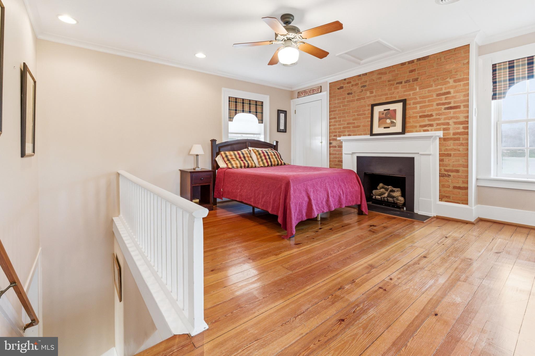 5329 Farmview Road Stanley, VA 22851 - Photo 46 of 111 a spacious bedroom with a bed and a fireplace
