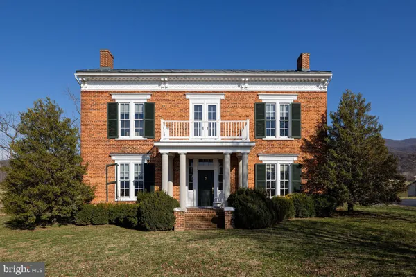 a view of a livingroom with wooden floor and stairs