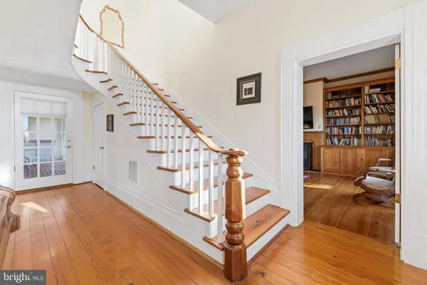 a kitchen with a table chairs sink and cabinets