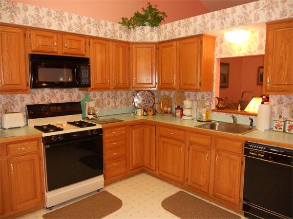 21 Ridgewood Drive, Unit 21 Atkinson, NH 03811 - Photo 3 of 13 a kitchen with stainless steel appliances a stove a sink and a microwave