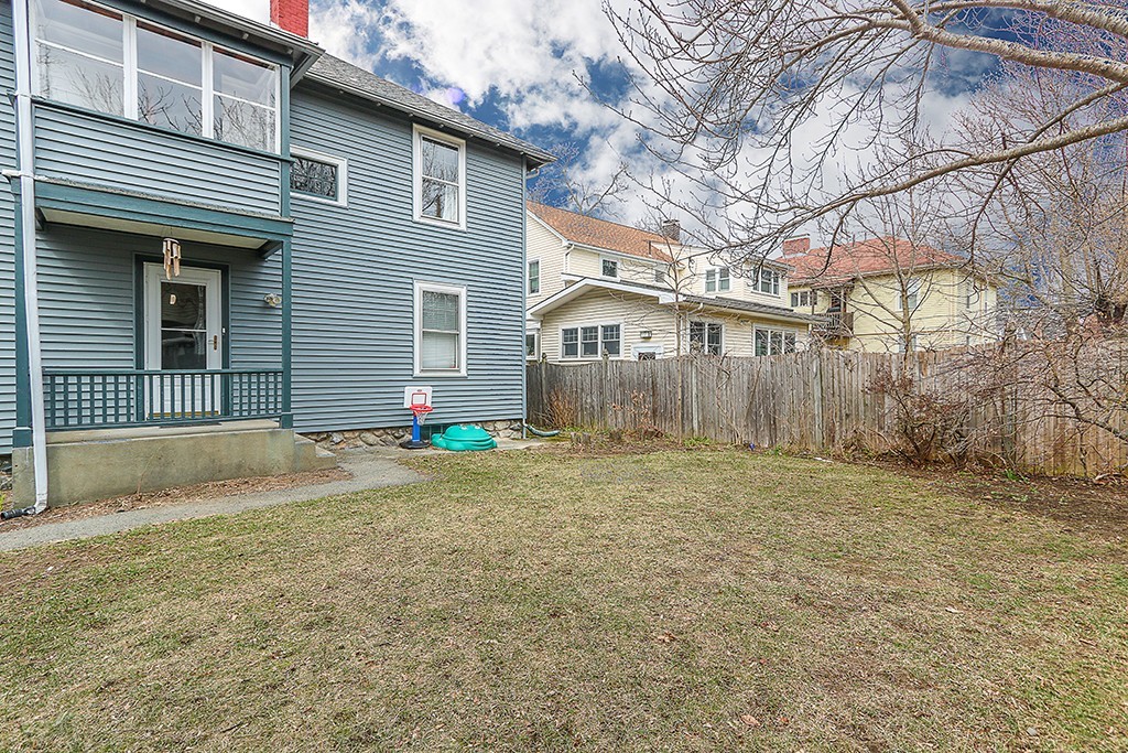 112-114 Adena Road, Unit 112 Newton, MA 02465 - Photo 16 of 16 a view of a house with a yard and garage