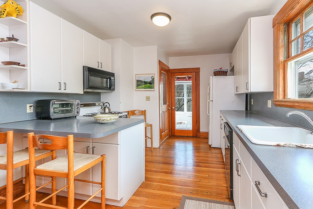 112-114 Adena Road, Unit 112 Newton, MA 02465 - Photo 3 of 16 a kitchen with stainless steel appliances granite countertop a sink stove and refrigerator