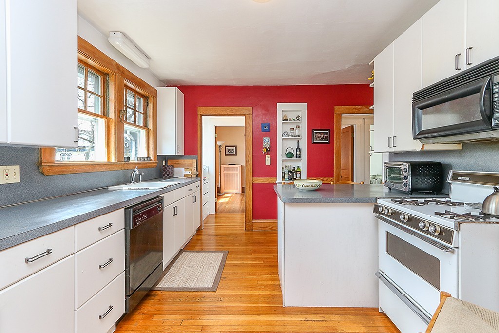 112-114 Adena Road, Unit 112 Newton, MA 02465 - Photo 4 of 16 a kitchen with stainless steel appliances kitchen island granite countertop a stove and a sink