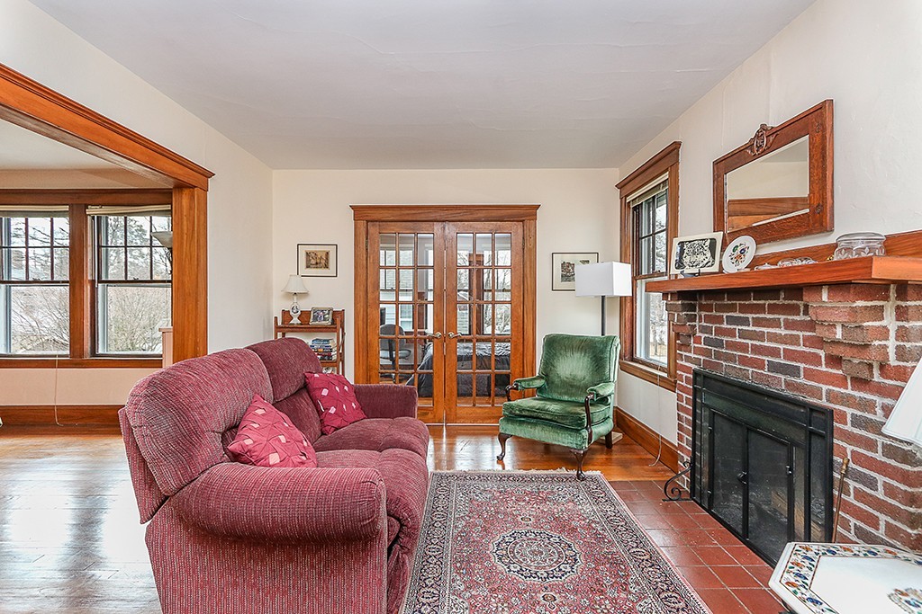 112-114 Adena Road, Unit 112 Newton, MA 02465 - Photo 9 of 16 a living room with furniture a rug potted plant and a fireplace