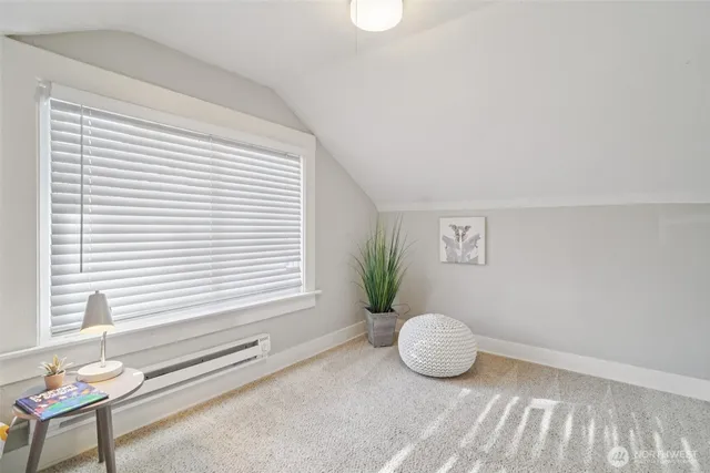 a view of a room with furniture and a window