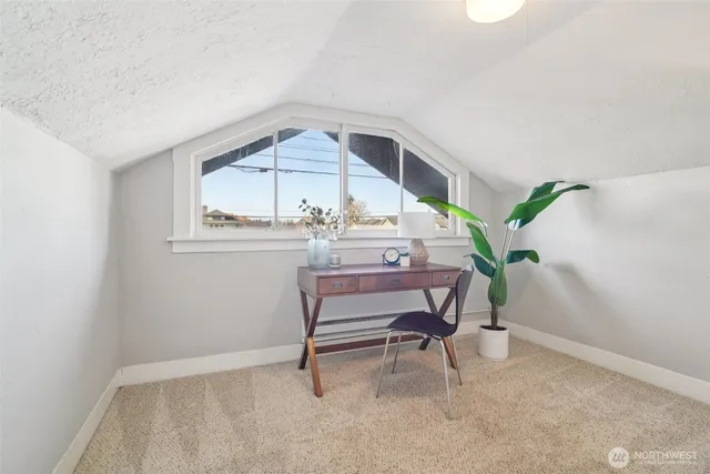 a view of workspace with furniture and wooden floor