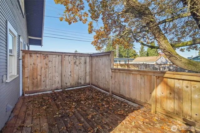 a view of a house with a yard and large trees