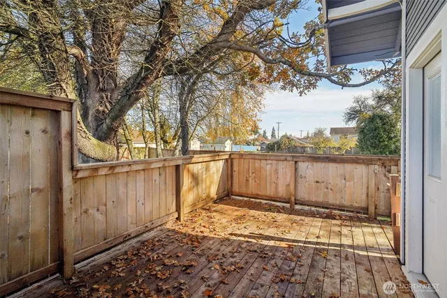 a view of yard with swimming pool and wooden fence