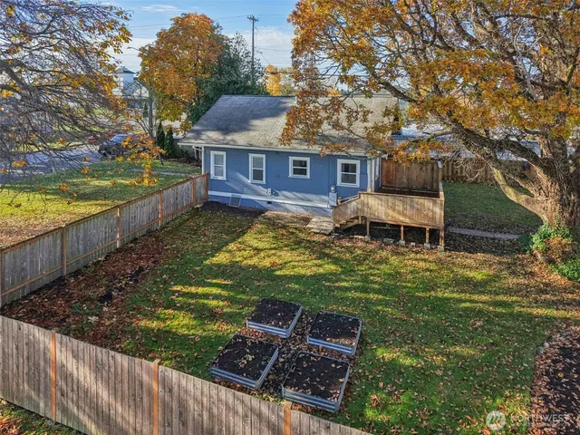 a backyard of a house with table and chairs