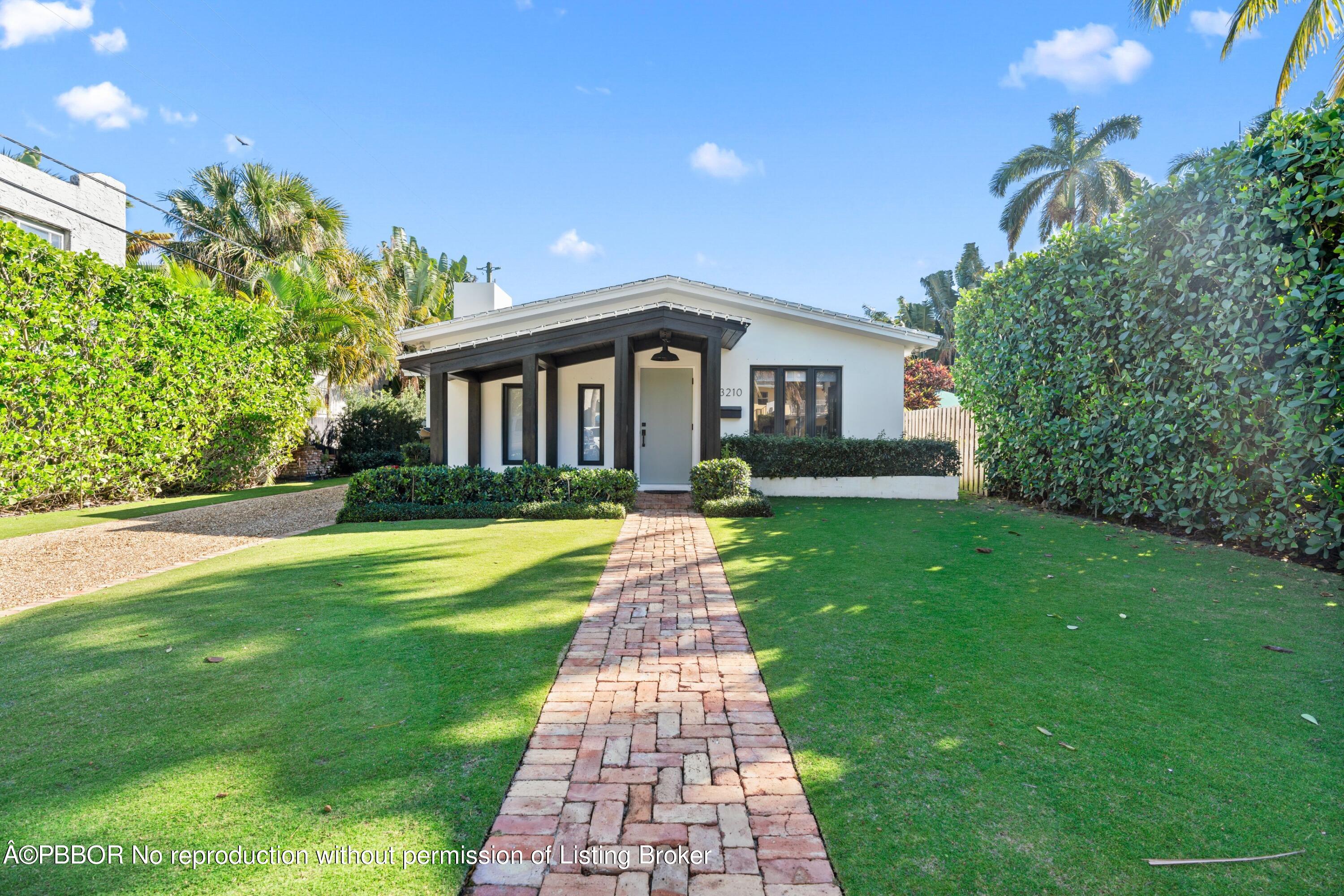 3210 Vincent Road West Palm Beach, FL 33405 - Photo 1 of 20 a front view of a house with a yard
