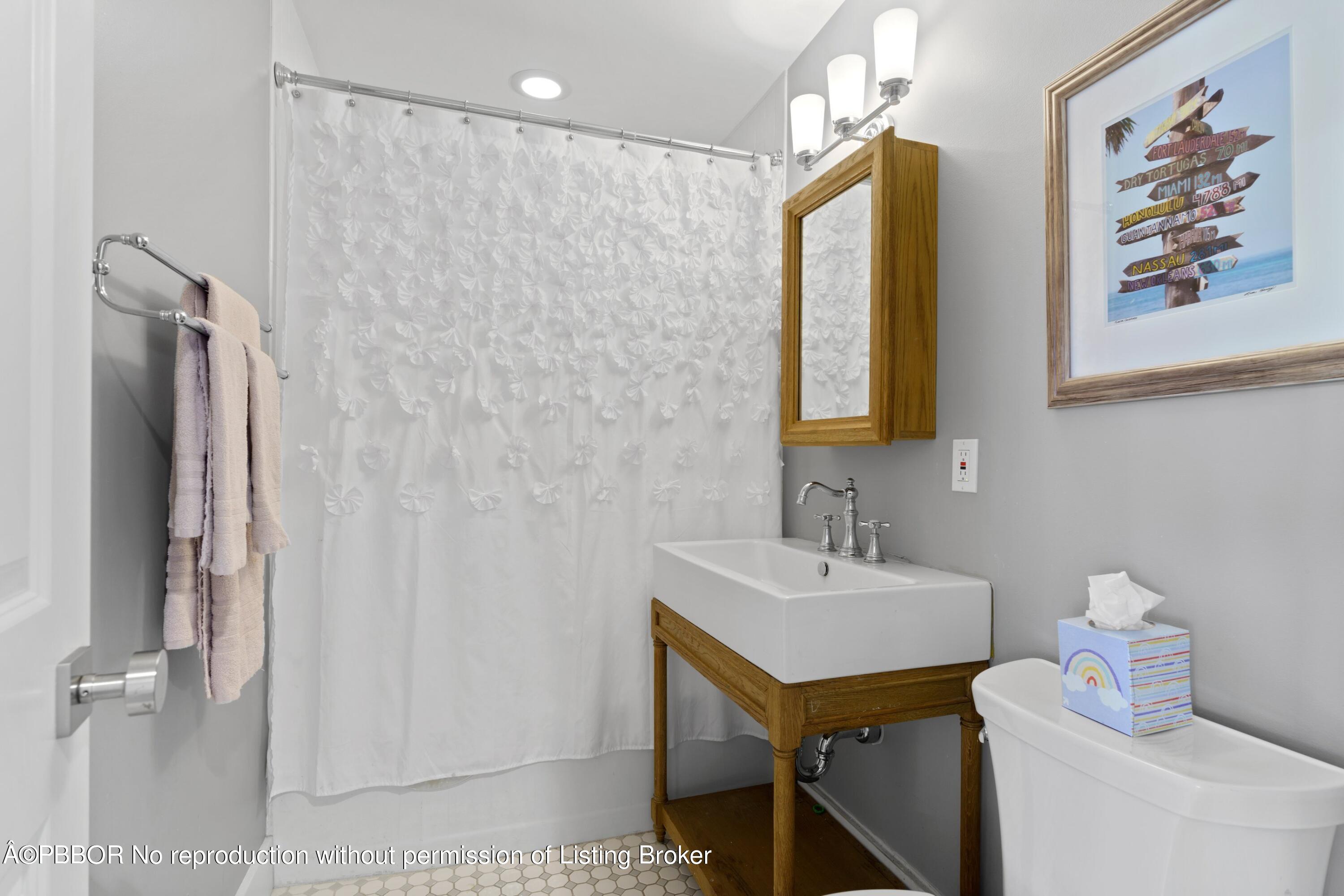 3210 Vincent Road West Palm Beach, FL 33405 - Photo 13 of 20 a bathroom with a sink and a mirror