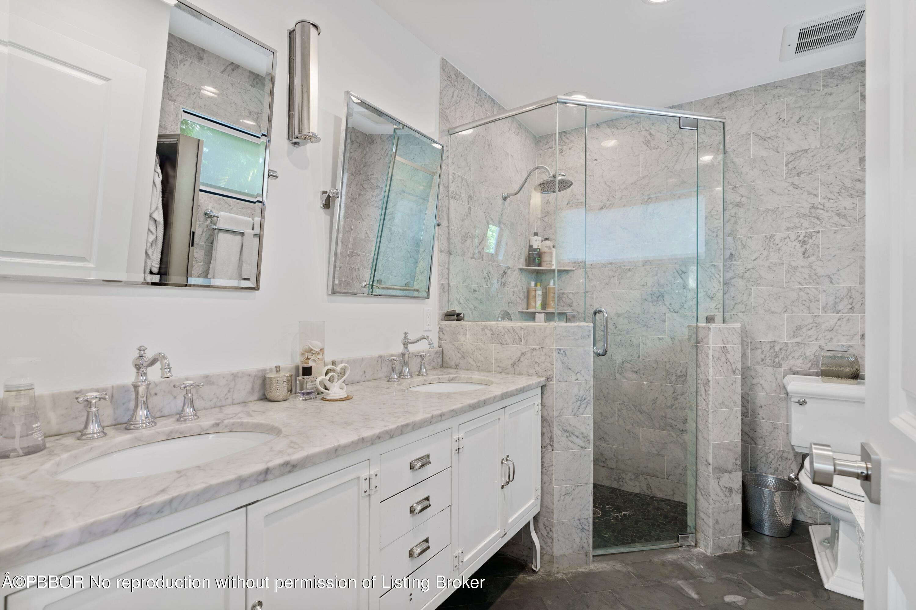 3210 Vincent Road West Palm Beach, FL 33405 - Photo 17 of 20 a bathroom with a granite countertop sink mirror and double