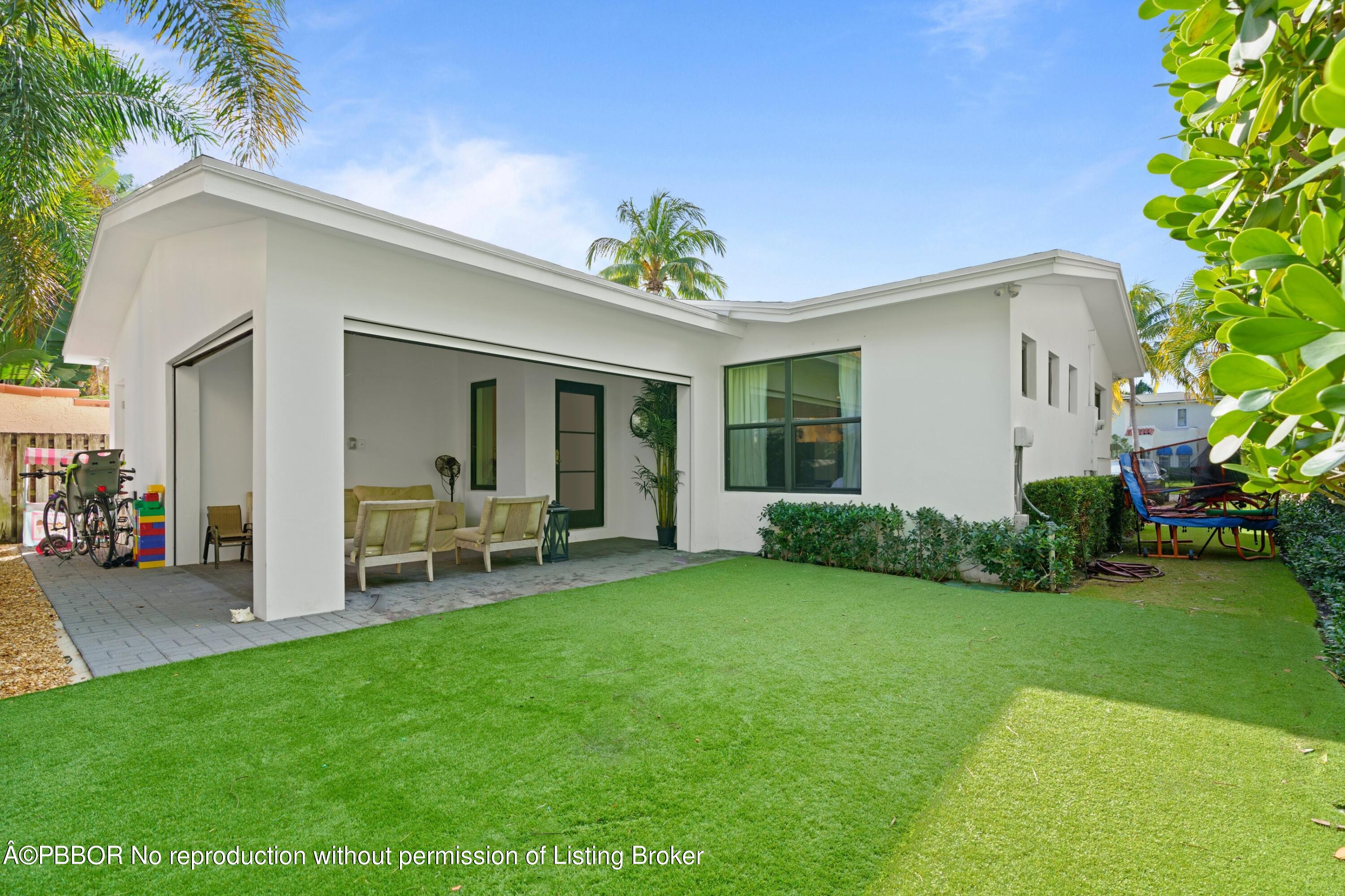 3210 Vincent Road West Palm Beach, FL 33405 - Photo 20 of 20 a view of a house with backyard porch and sitting area