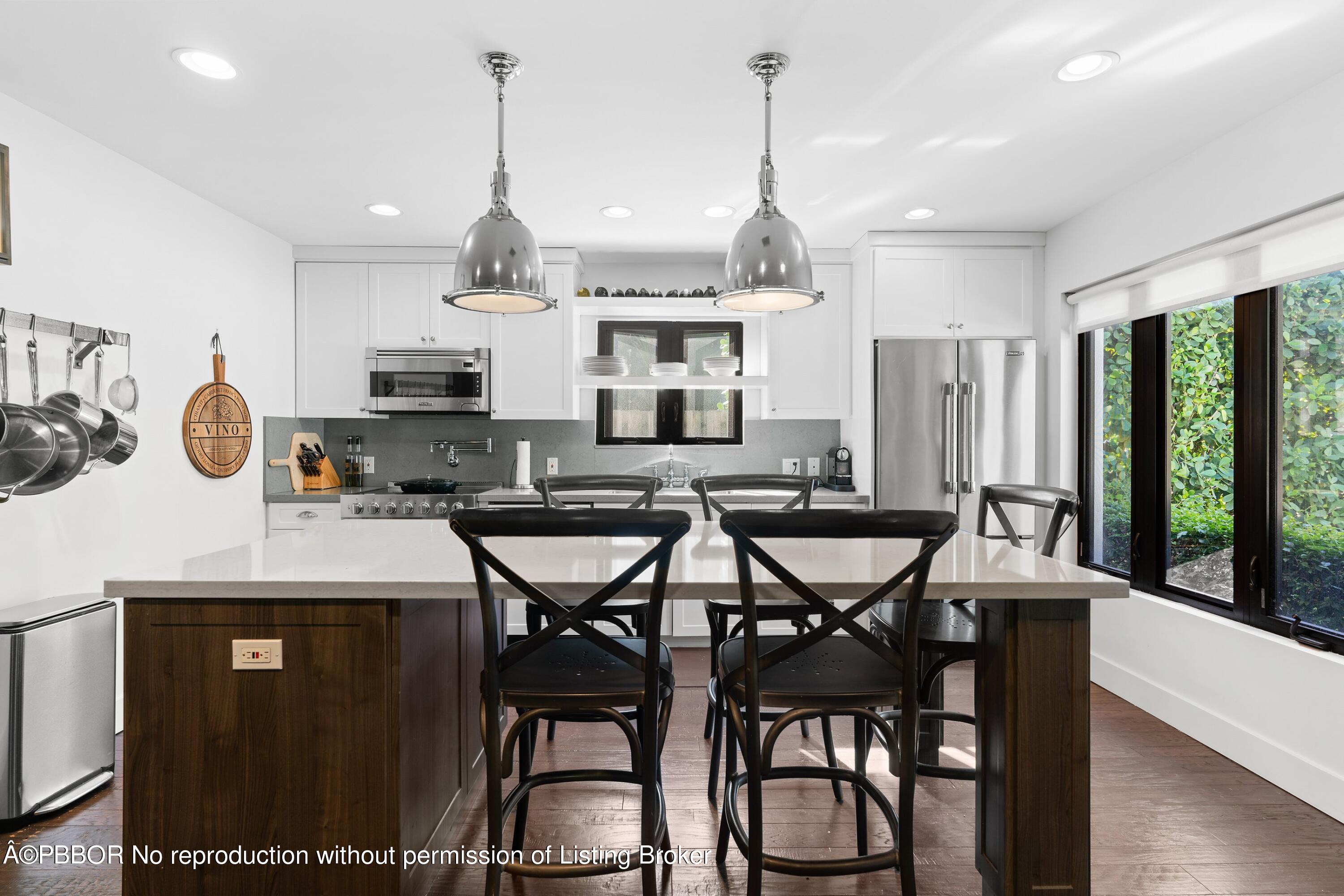 3210 Vincent Road West Palm Beach, FL 33405 - Photo 2 of 20 a view of a dining room with furniture window and wooden floor