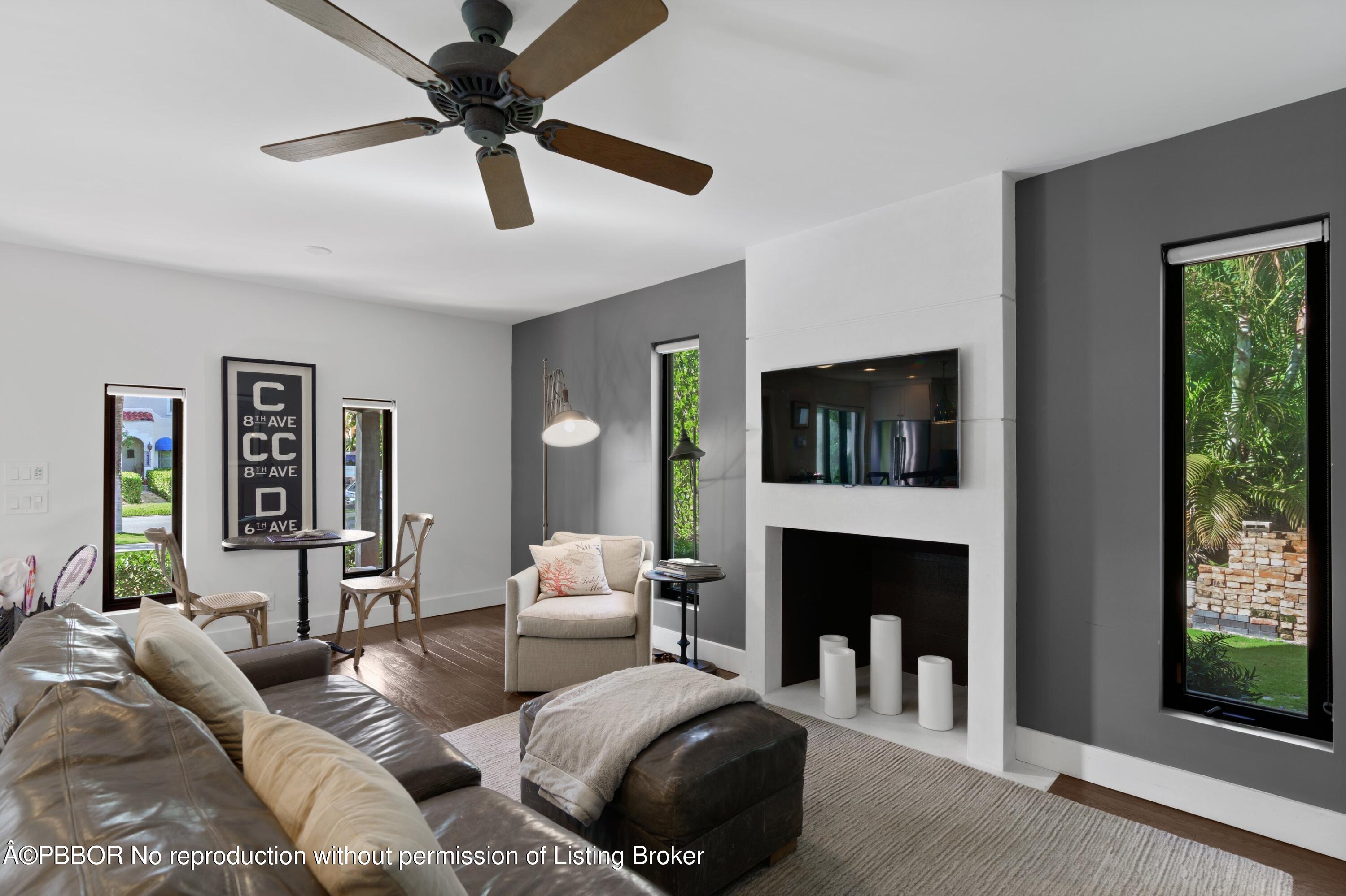 3210 Vincent Road West Palm Beach, FL 33405 - Photo 3 of 20 a living room with furniture and a fireplace