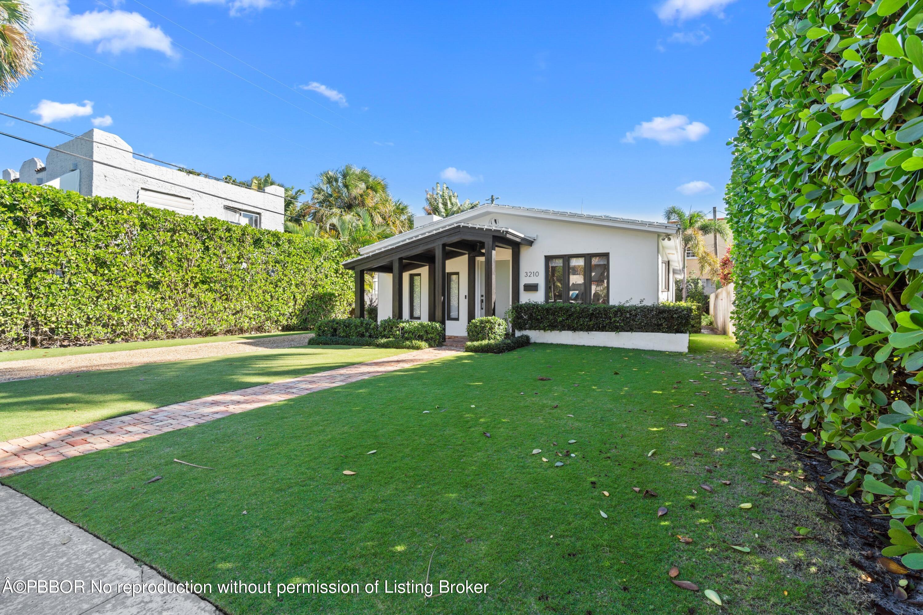 3210 Vincent Road West Palm Beach, FL 33405 - Photo 5 of 20 a front view of a house with garden