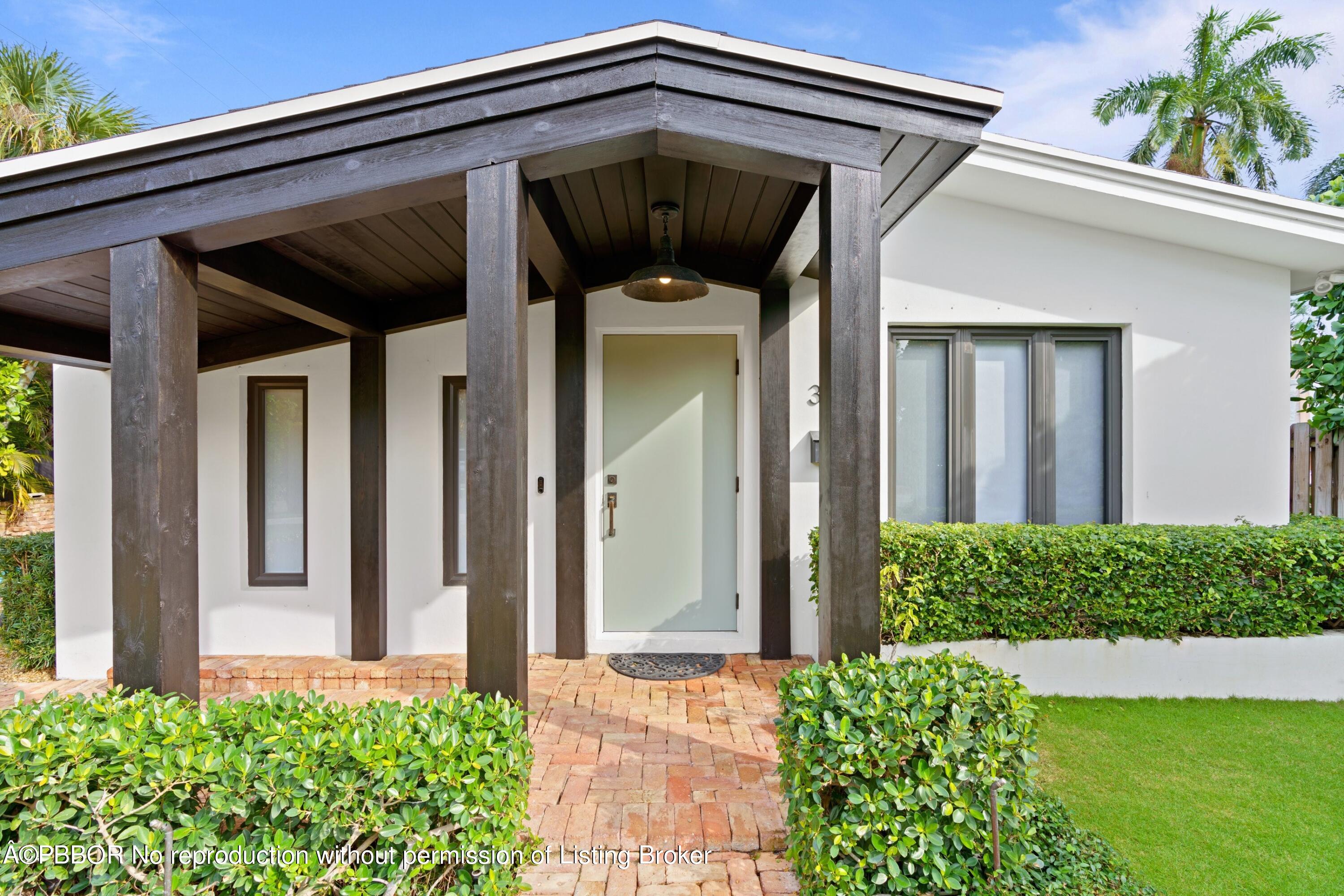 3210 Vincent Road West Palm Beach, FL 33405 - Photo 6 of 20 a front view of a house with a yard