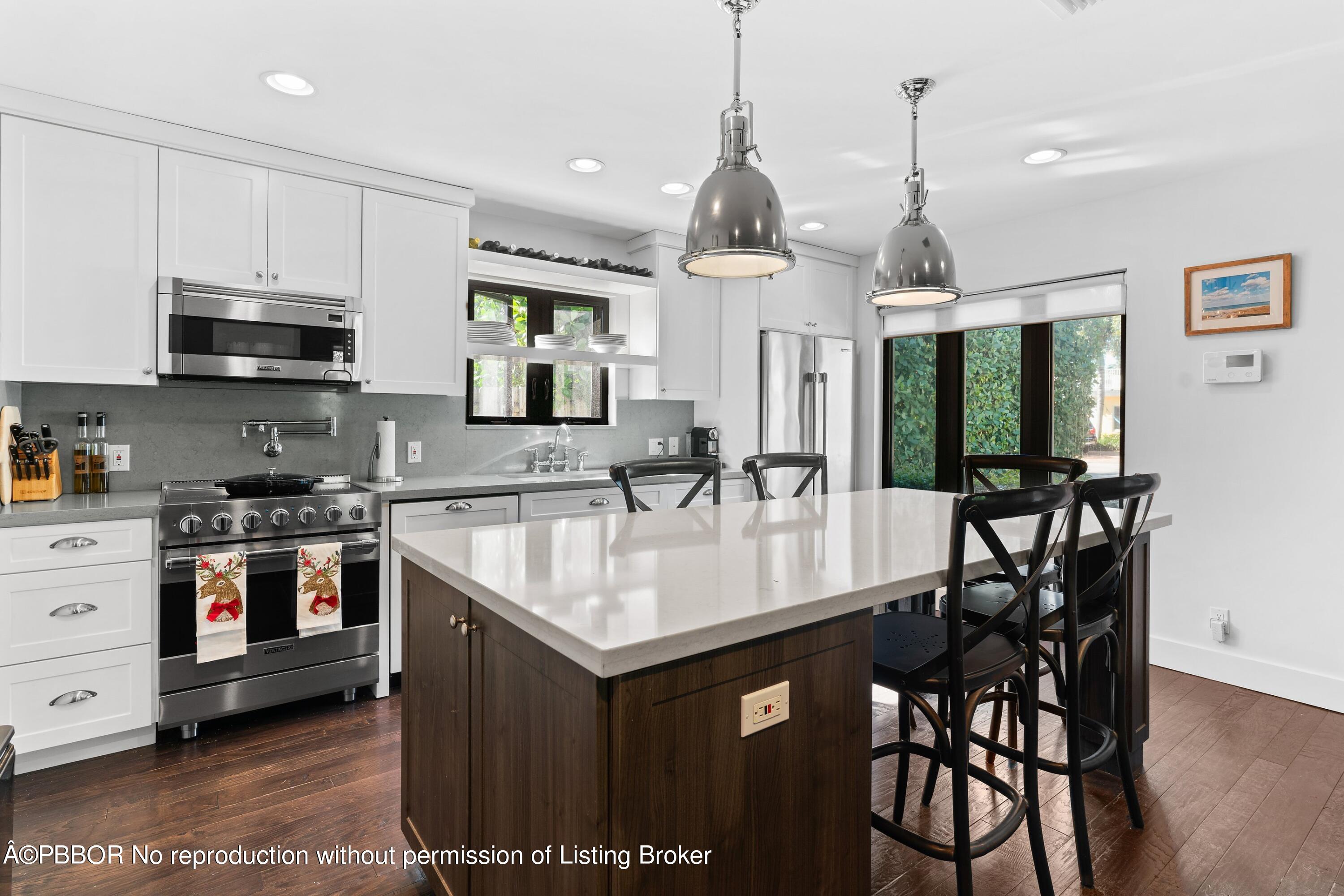 3210 Vincent Road West Palm Beach, FL 33405 - Photo 7 of 20 a kitchen with stainless steel appliances granite countertop a sink a stove and a wooden floors