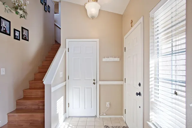 a view of staircase with white walls and a window