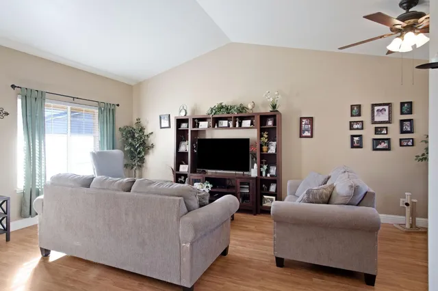 a living room with furniture and a flat screen tv